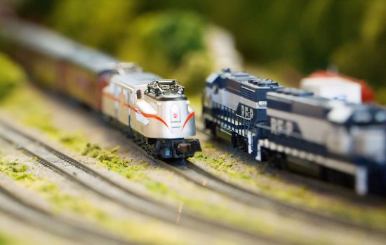 Close up image of two model trains on tracks
