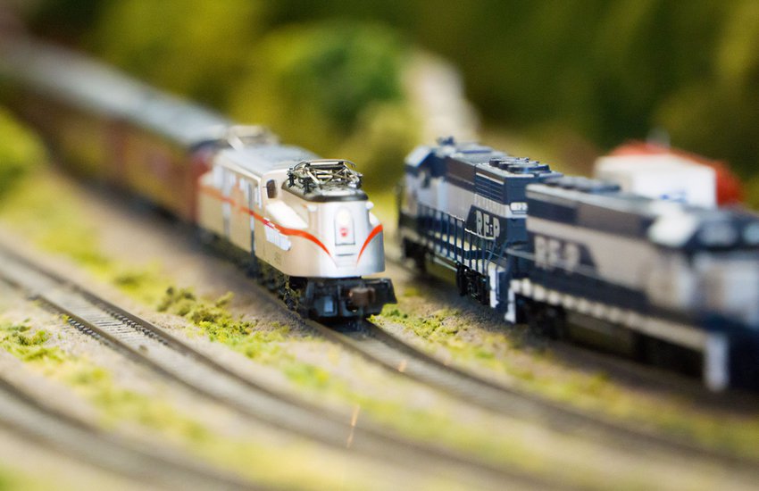 Close up image of two model trains on tracks