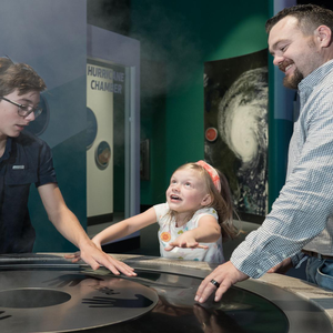 family of three interacting with steam exhibit at the Science Center.jpg