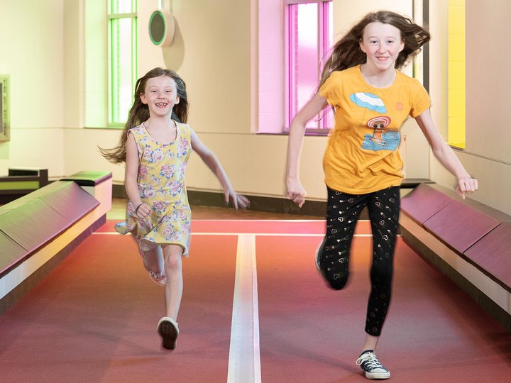 Two girls running on the track in the Go exhibition
