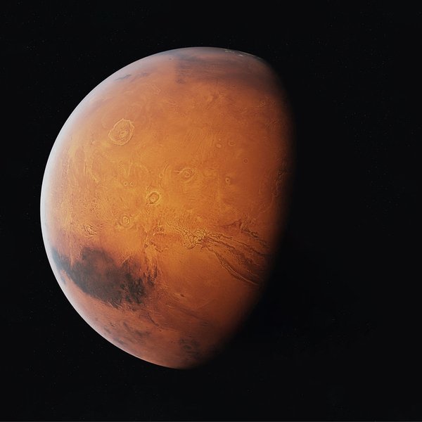 planet with a red hue and cratered surface known as Mars.jpg