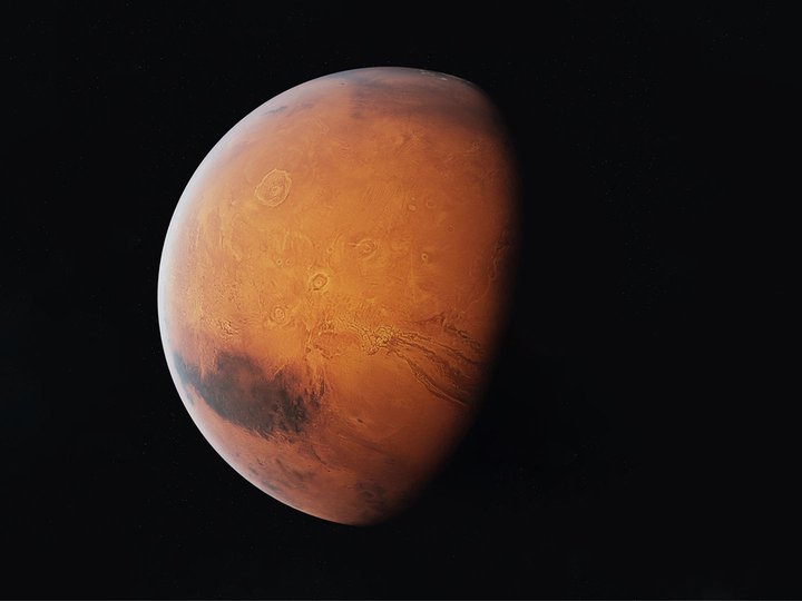 planet with a red hue and cratered surface known as Mars.jpg