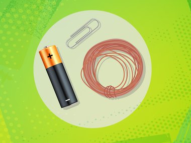 Battery, metal wire and paper clip on a lime green background. Parts used to make a simple motor.