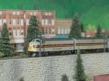 model train traveling in a town.jpg