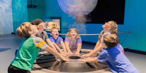 children surrounding the water vapor exhibit.jpg
